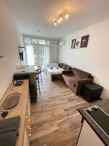 a living room with a couch and a table at Violett Apartman in Balatonberény