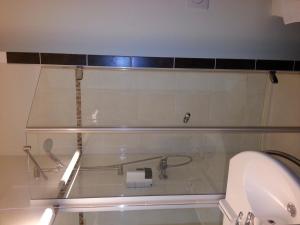 een badkamer met een douche, een toilet en een wastafel bij Hôtel Akena City Caudry in Caudry