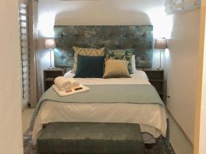 a bedroom with a large bed with a headboard at Paarl Views in Paarl