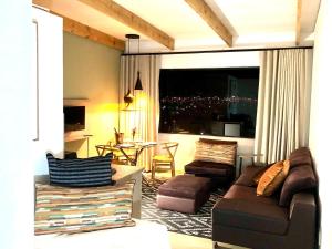 a living room with a couch and chairs and a table at Paarl Views in Paarl
