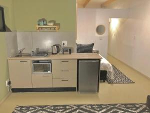 a kitchen with a sink and a stove top oven at Paarl Views in Paarl