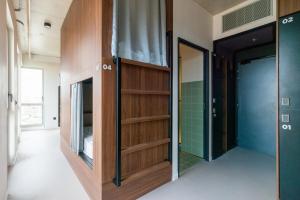 a hallway with wooden shelves and a door in a room at JOST Auberge de Jeunesse Bordeaux Gare St Jean in Bordeaux +44 photos