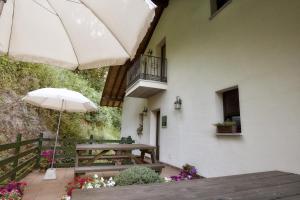 eine Terrasse mit Tisch und Sonnenschirm in der Unterkunft Apartamentos el Caserón in Soto de Cangas