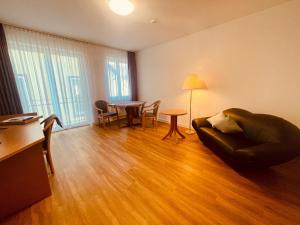 a living room with a couch and a table at Apartment 4 in Braunsbach