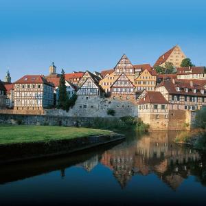 a group of buildings sitting next to a river at Apartment 4 in Braunsbach