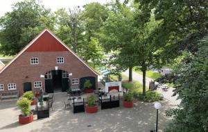 an aerial view of a red barn with tables and chairs at De Schuure 't Voorde in Winterswijk in Winterswijk