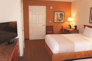 a hotel room with a bed and a flat screen tv at Baymont by Wyndham San Antonio South Park in San Antonio