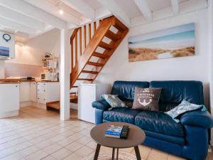 a living room with a blue couch and a table at La Trinité/Mer - Appartement 3 pièces, 5 pers, proche port et plage - FR-1-477-164 in La Trinité-sur-Mer