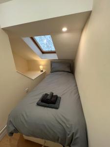 a small bedroom with a bed in a attic at Cozy Penthouse suite happily sleeps up to five in Halifax