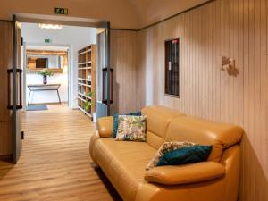 a living room with a couch and a hallway at Chata u kostela in Kořenov