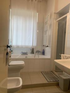 a bathroom with a tub and a toilet and a sink at La casa di Miretta in Chieti