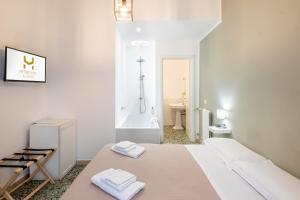 a white room with a bed and a bath tub at My Tiny Home Alchemy in Rome