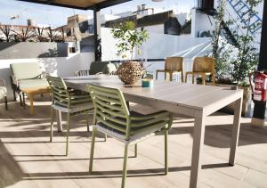 a dining table and chairs on a patio at Casa Rural Casa Levante in Arcos de la Frontera