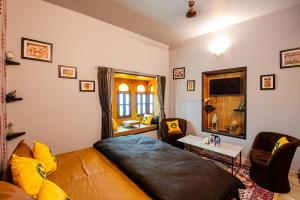 a bedroom with a bed and a desk and a window at The Hosteller Jodhpur, Old in Jodhpur