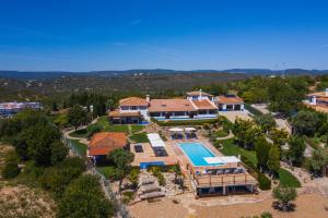 an aerial view of a house with a swimming pool at Shantivillas Malhão in Azinhal