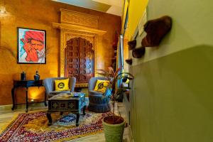 a living room with two chairs and a table at The Hosteller Jodhpur, Old in Jodhpur