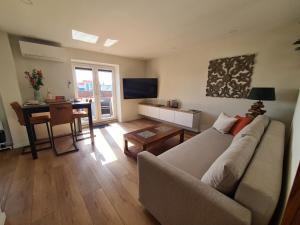 a living room with a couch and a table at Sunnyzandvoort in Zandvoort