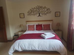 a bedroom with a large bed with two towels on it at Apartment at Drummond Crescent in Inverness