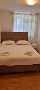 a bed with two towels on it in a bedroom at Holiday Home Zezevica - Heated Pool in Šestanovac