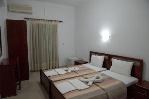 Postel nebo postele na pokoji v ubytování Hotel Glaros