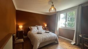 Ένα ή περισσότερα κρεβάτια σε δωμάτιο στο Maison familiale au cœur du Marquenterre