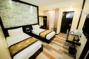 Posteľ alebo postele v izbe v ubytovaní SunCity Suites
