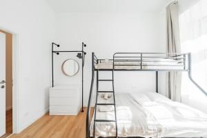 a bedroom with a bunk bed and a mirror at Modern Central City Rooms in Vienna