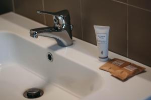 un lavandino in bagno con spazzolino e tazza sopra di La casa sull'Isola Pescatori a Stresa