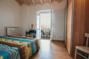 a bedroom with a bed and a door to a balcony at La casa sull'Isola Pescatori in Stresa +12 photos