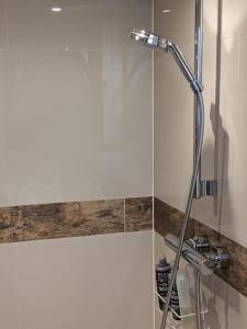 a shower with a glass door in a bathroom at Comfortable stylish room in Hanwell in Greenford