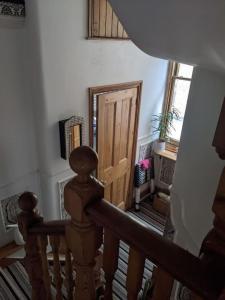a staircase with a wooden door in a room at Comfortable stylish room in Hanwell in Greenford