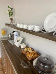 a kitchen with a counter with a basket of bread at Hotel Manarela in Imperatriz