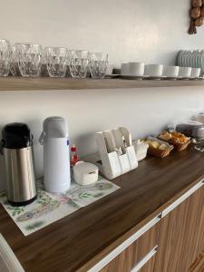 a kitchen counter with a coffee maker on a counter top at Hotel Manarela in Imperatriz