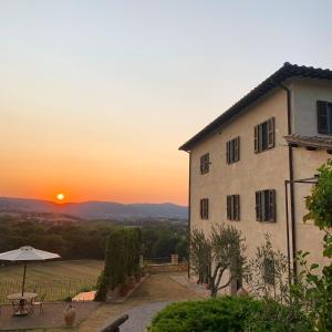 a building with a sunset in the background at Torre Palombara - Dimora Storica in Narni