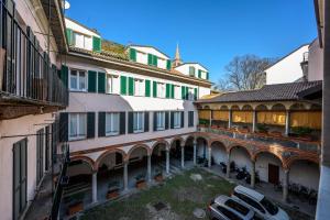 an apartment building with cars parked in a courtyard at tHE Lantern Flat in Milan