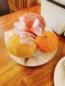 a plate with two donuts with a flower on it at Opera Premier Hotel in Luang Prabang