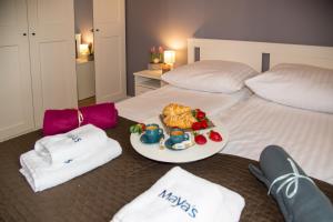 a bed with a plate of food on it at Maya's Flats & Resorts 62 - 3 rooms apartment BASTION WALOWA Gdańsk in Gdańsk