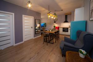 a living room and kitchen with a table and chairs at Maya's Flats & Resorts 62 - 3 rooms apartment BASTION WALOWA Gdańsk in Gdańsk
