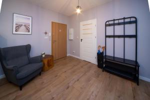 a living room with a chair and a bunk bed at Maya's Flats & Resorts 62 - 3 rooms apartment BASTION WALOWA Gdańsk in Gdańsk