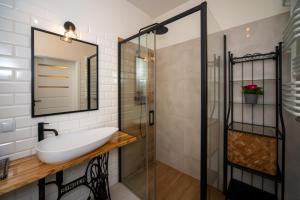a bathroom with a sink and a shower at Maya's Flats & Resorts 62 - 3 rooms apartment BASTION WALOWA Gdańsk in Gdańsk +29 photos