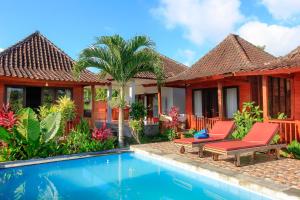 a villa with a swimming pool in front of a house at THE DARA HILL in Nusa Penida