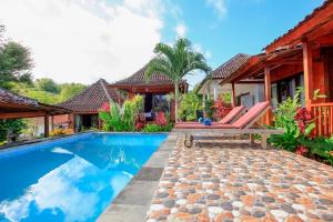 a villa with a swimming pool and a house at THE DARA HILL in Nusa Penida