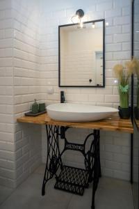 a bathroom with a sink and a mirror at Maya's Flats & Resorts 62 - 3 rooms apartment BASTION WALOWA Gdańsk in Gdańsk