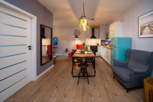a kitchen and living room with a table and a blue chair at Maya's Flats & Resorts 62 - 3 rooms apartment BASTION WALOWA Gdańsk in Gdańsk