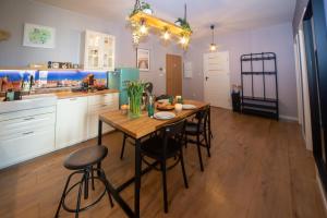 a kitchen with a wooden table and some chairs at Maya's Flats & Resorts 62 - 3 rooms apartment BASTION WALOWA Gdańsk in Gdańsk