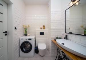 a white bathroom with a washing machine and a sink at Maya's Flats & Resorts 62 - 3 rooms apartment BASTION WALOWA Gdańsk in Gdańsk