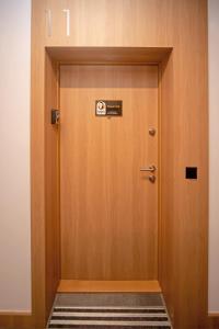 a wooden elevator door with a sign on it at Maya's Flats & Resorts 62 - 3 rooms apartment BASTION WALOWA Gdańsk in Gdańsk