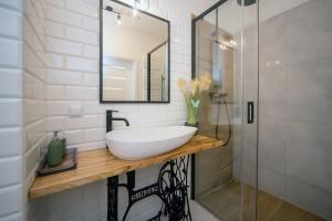 a bathroom with a white sink and a mirror at Maya's Flats & Resorts 62 - 3 rooms apartment BASTION WALOWA Gdańsk in Gdańsk