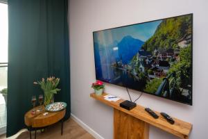 a living room with a large flat screen tv on a wall at Maya's Flats & Resorts 62 - 3 rooms flat in Walowa Gdańsk in Gdańsk