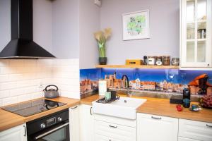 a kitchen with a sink and a counter top at Maya's Flats & Resorts 62 - 3 rooms apartment BASTION WALOWA Gdańsk in Gdańsk